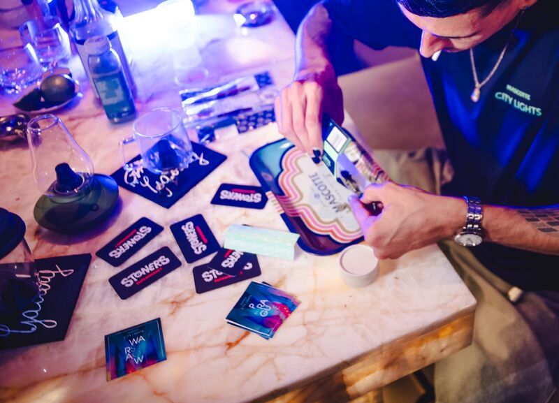 Patches, pins and stickers spread across the marble table at a customising night.