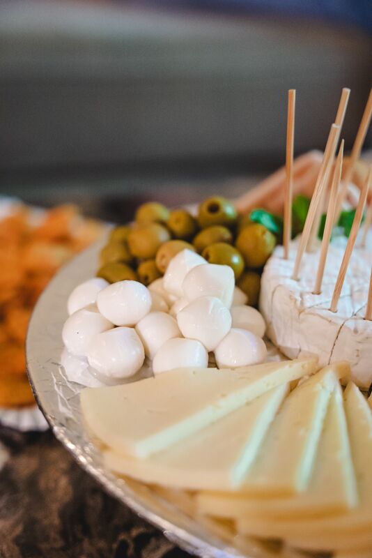 A platter of manchego, mozzarella and green olives on the bar.